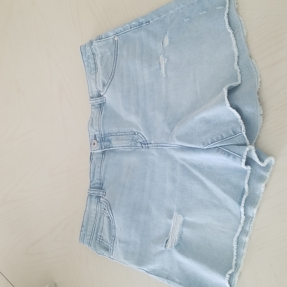 Cut off New with tags mid rise, fray hem . Denim shorts light wash